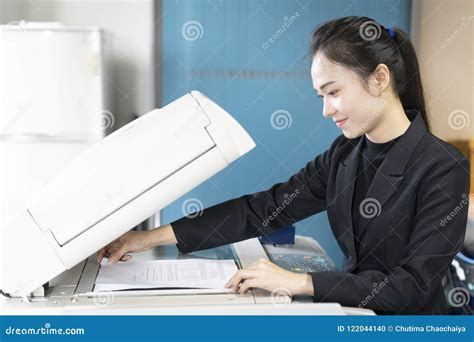 woman secretary hand putting  sheet  paper   copying device