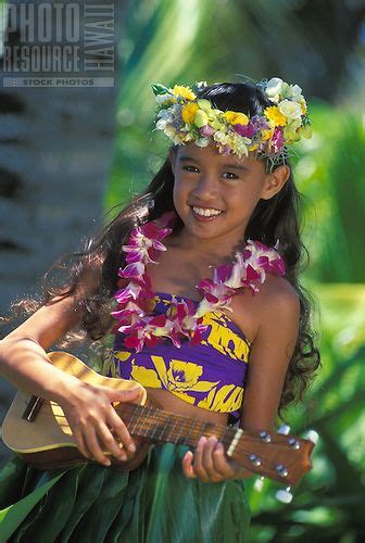 beautiful hawaiian girl age 7 playing ukulele with orchid lei haku