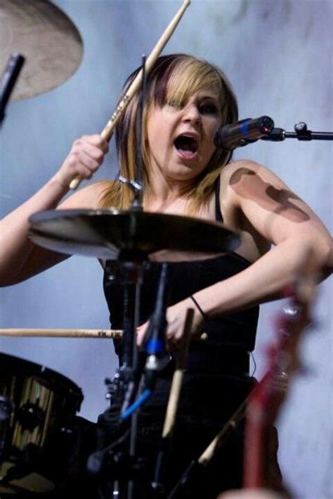 A Woman Is Playing Drums On Stage
