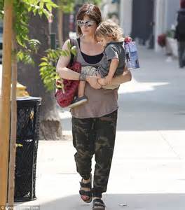 selma blair carries wo takeaways back to her car her son