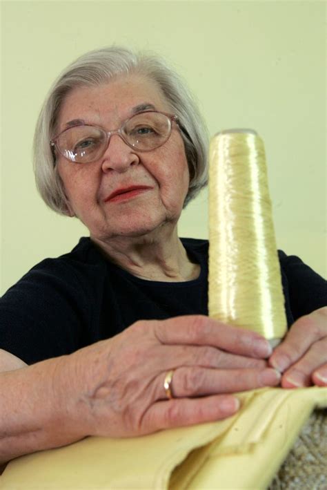 an older woman holding a yellow object in her hands