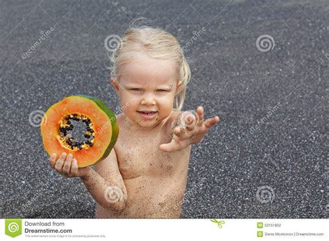 Little Cute Girl On The Sea Beach With Sweet Orange Papaya
