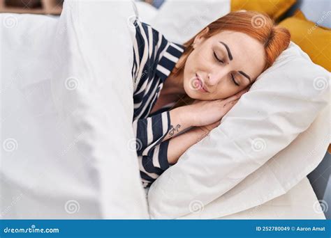 Young Caucasian Woman Lying On Bed Sleeping At Bedroom Stock Image