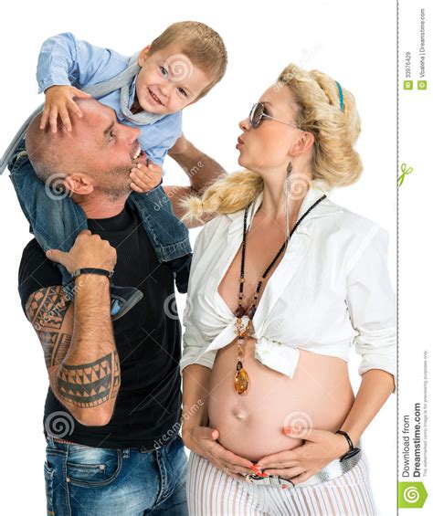 pregnant woman with her husband and her son kissing her