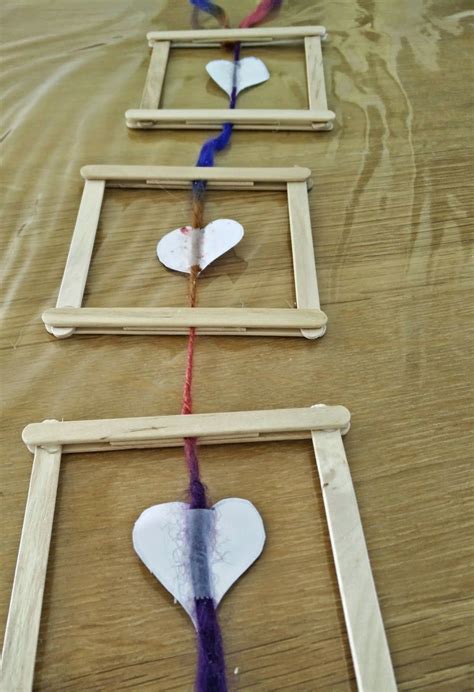 wooden frames  paper hearts hanging     table    yarn
