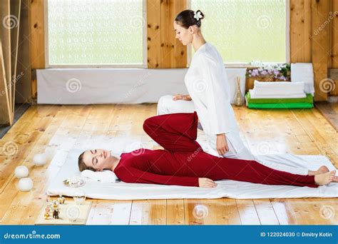 Woman Getting Traditional Thai Stretching Massage By Therapist Stock