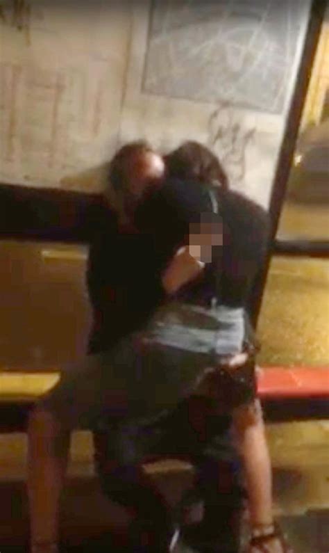 brazen couple shock onlookers as they romp in a bus stop for half an hour