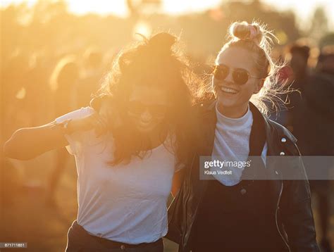 friends laughing together at big festival photo getty images