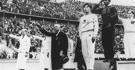 jesse owens on the podium at the 1936 berlin olympics