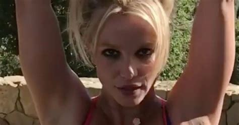 britney spears boobs burst out of her sports bra as she performs seductive workout in her back