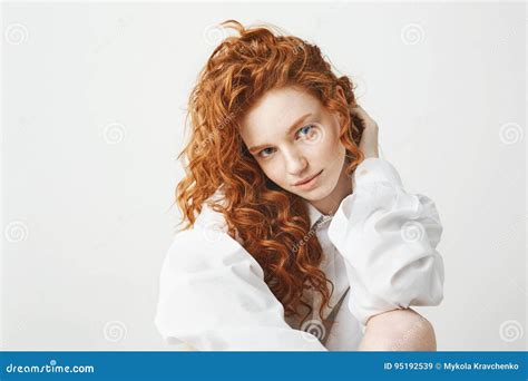 Portrait Of Cute Tender Ginger Girl With Curly Hair Looking At Camera