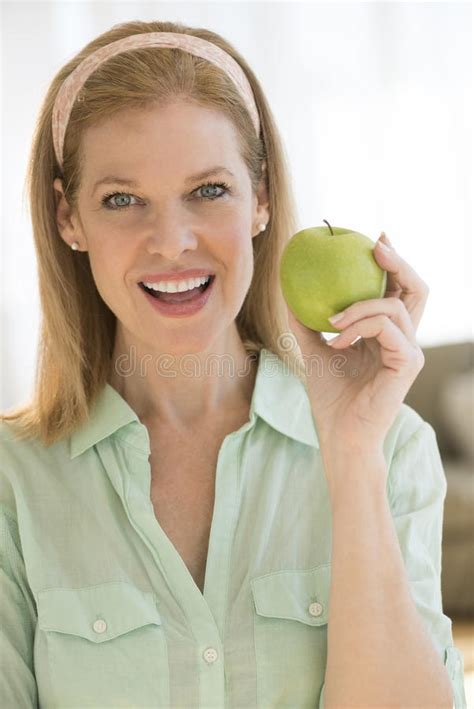 Happy Mature Woman Holding Granny Smith Apple Home Photos Free