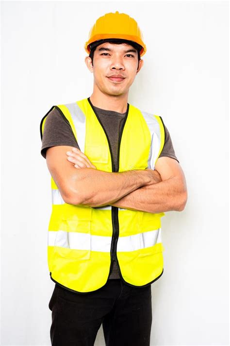 Asian Men Wear Green Reflective Safety Shirts And Yellow Helmet On