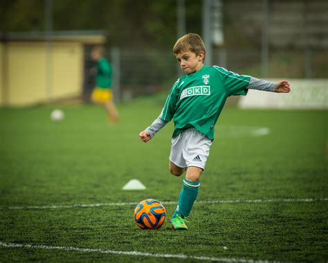 images play green soccer child sports sphere footballer kick football player