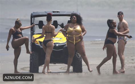 Lizzo Stands In A Tiny Metallic Gold One Piece Whilst With Her