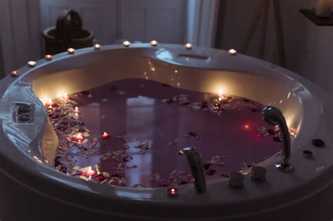 flower petals  spa tub  water  burning candles  edges photo