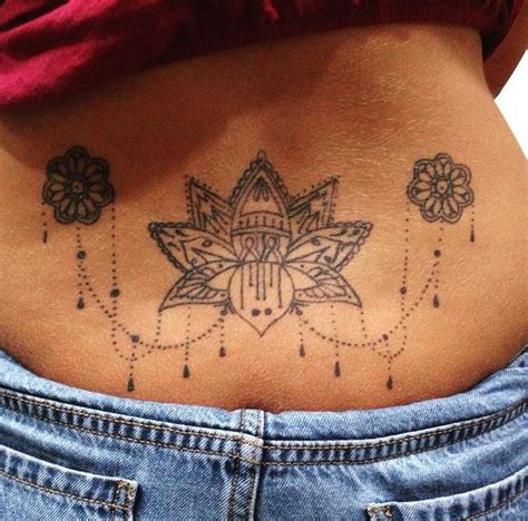 lotus flower lower back tattoo dont like the small ones on side but