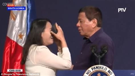 phillipine president rodrigo duterte kisses filipino worker on stage