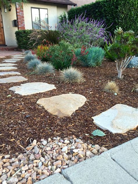 paving stone pathway surrounded  mulch bark  complete