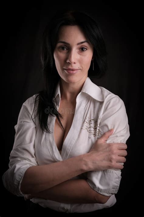 Portrait Of Beautiful Mature Brunette Woman Dressed In White Shirt
