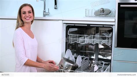 Blonde Woman Put Her Dishes In Dishwasher And Does Stock Video Footage