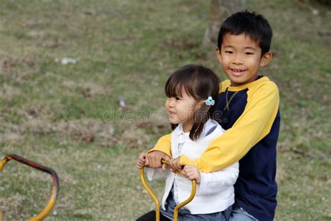 japanese brother and sister on the seesaw stock image image of