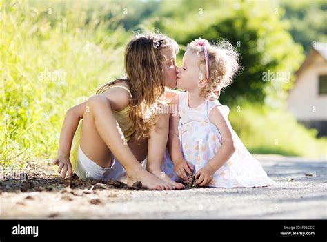 kissing cute  sisters high resolution stock photography