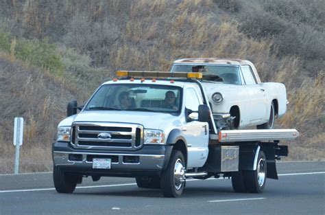 securing  car   flatbed tow truck timber towing  recovery