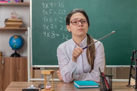Free Photo Young Woman Teacher Wearing Glasses Looking Aside With