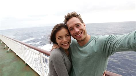 romantic happy couple on cruise ship on boat travel embracing looking at view happy lovers