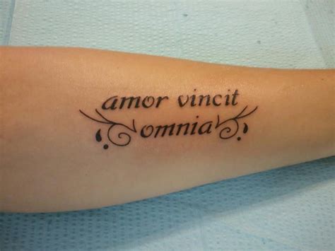 my first tattoo love conquers all in latin word tattoos tattoo quotes mens shoulder tattoo