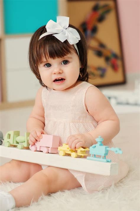 cute happy  year  baby girl playing  wooden toys  home stock