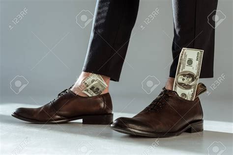 close  view  dollar bills  businessmans shoes aff dollar