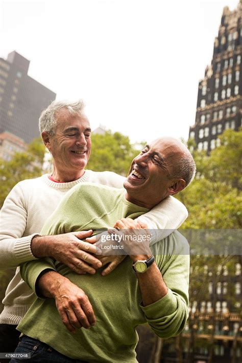 happy mature gay couple having fun outdoor in the city