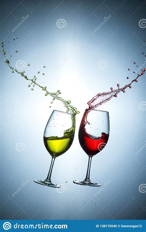 Two Types Of Wine Splashes Poured Out From Glasses Against Bluish