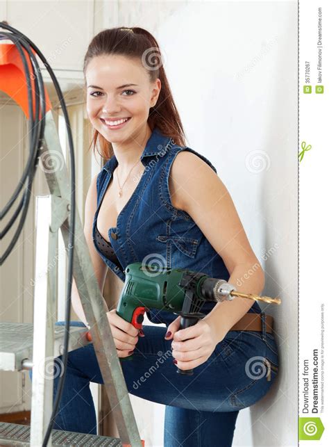 Portrait Of Girl In Overalls With Drill Stock Image
