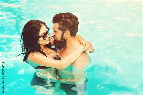 Young And Attractive Couple Hugging In Swimming Pool Dream Vacation In
