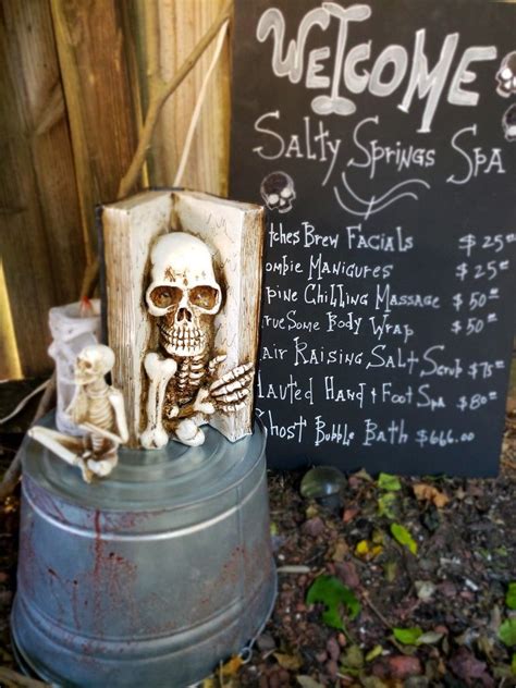 skeleton statue sitting  top   metal barrel    sign