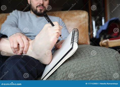 close  picture  man writing  text   notebook   toes   foot stock image