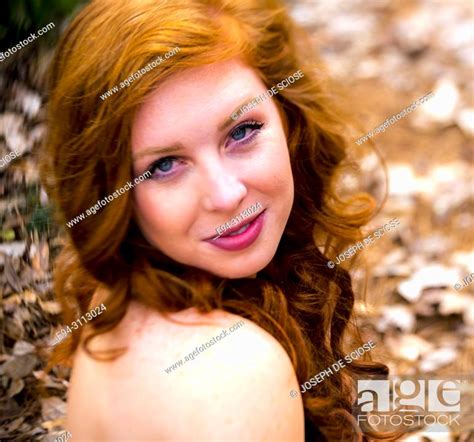 A Portrait Of A Pretty 25 Year Old Redheaded Woman Smiling At The