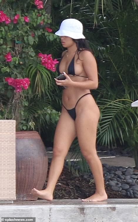 diddy keeps things casual as he relaxes with a bikini clad female