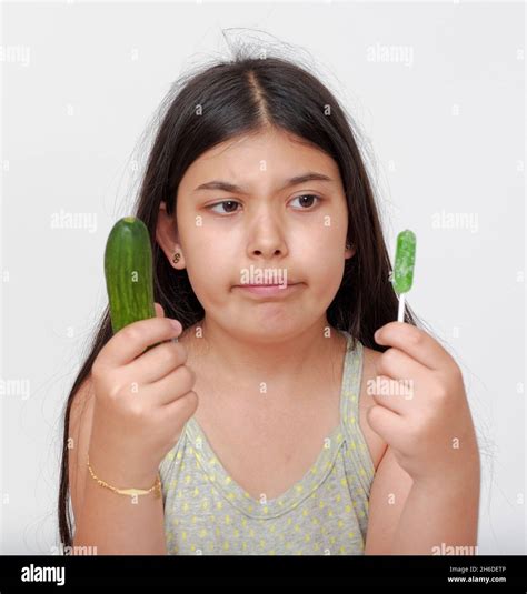 Young Chubby Girl Has To Choose Between Healthy Diet Of Vegetables