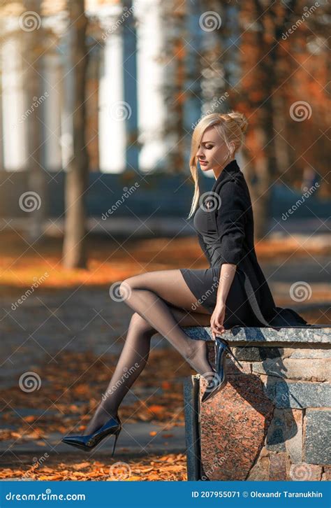 Beautiful Blonde Woman With Perfect Legs In Pantyhose Posing Outdoor At