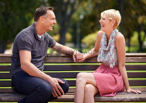 Enjoying Some Light Banter In The Park A Mature Couple Enjoying A