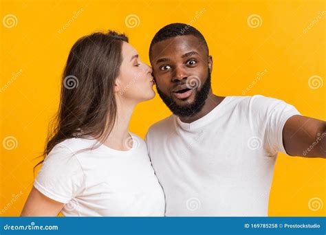 Young Interracial Couple In Love Taking Selfie Together Woman Kissing