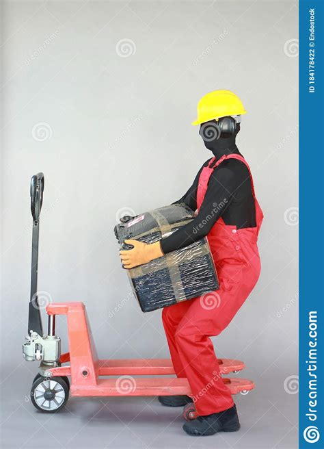 anonymous worker lifting heavy package profile view stock photo image  dungarees health