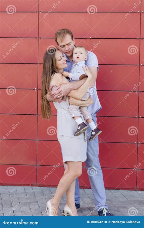 portrait   young family   red background stock photo image  girl recreation