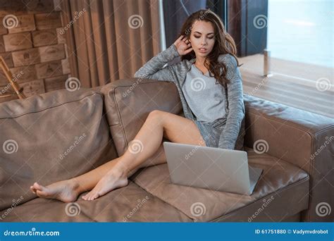 young woman sitting  sofa  concentrate   laptop stock photo image  female