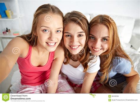 amici felici o ragazze teenager che prendono selfie a casa fotografia