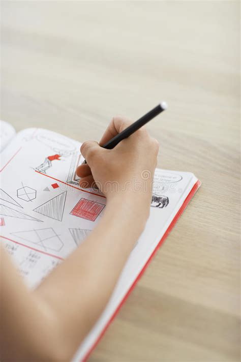 brother and sister doing homework in kitchen stock image